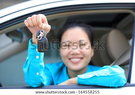 happy woman driver with her first car