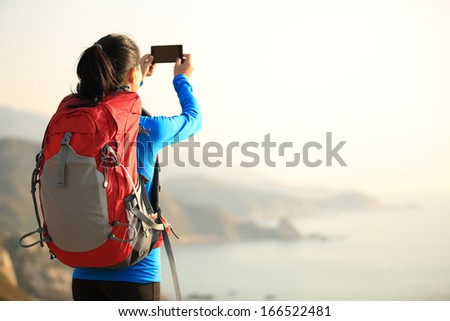 Similar – Image, Stock Photo Woman with backpack taking selfie on smartphone on background of mountains