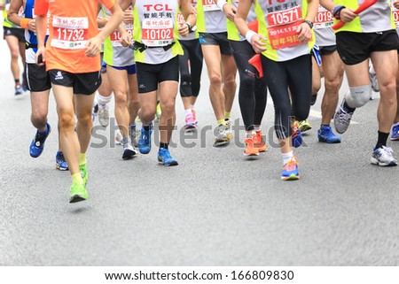 SHENZHEN, CHINA - DEC 08: Dozens of Unidentified athletes running at the shenzhen international marathon 2013, shennan road,shenzhen city,China,on DEC 08,2013 at Shenzhen city,Guangdong province,China.