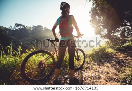 Similar – Image, Stock Photo Young woman mountain biking