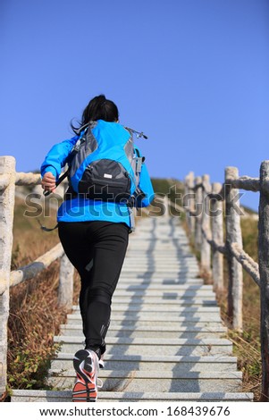 hiking woman climbing mountain stairs