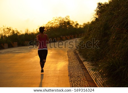 healthy asian woman runner running outdoor under sunrise
