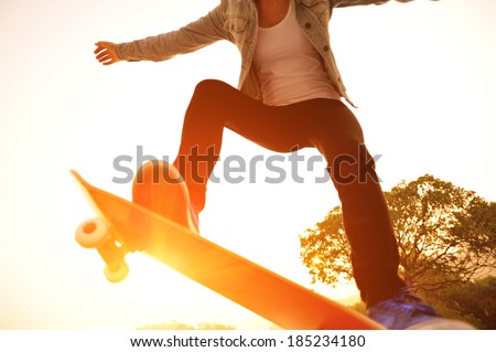 sunrise skateboarding woman