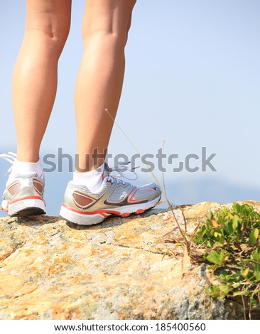 hiking legs stand seaside mountain rock