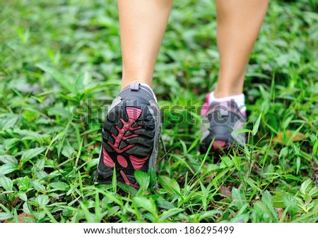 running feet on green grass