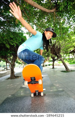 skateboarding woman at skateboard park