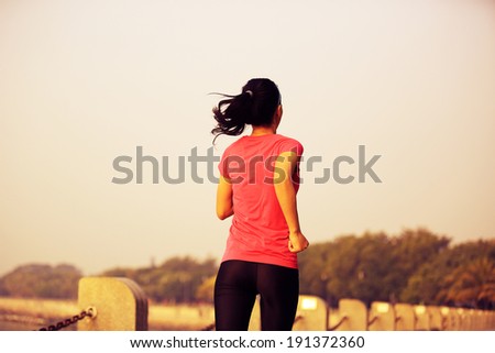 Runner athlete running at seaside. woman fitness jogging  workout wellness concept.