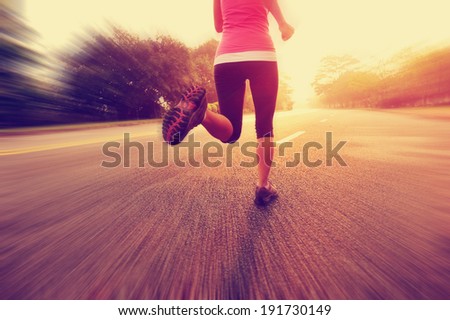 Runner athlete running on road. woman fitness sunrise jogging  workout wellness concept.