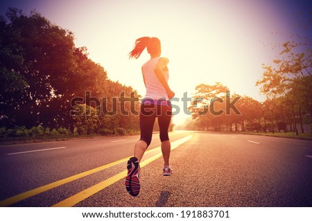 Runner athlete running on road. woman fitness sunrise jogging  workout wellness concept.