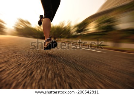 Runner athlete running at road. woman fitness sunrise jogging workout wellness concept.