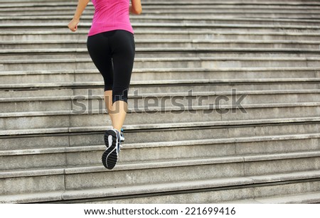 Runner athlete running on city stairs. woman fitness jogging workout wellness concept.