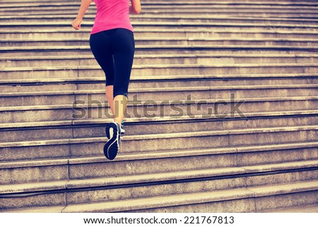 Runner athlete running on city stairs. woman fitness jogging workout wellness concept.