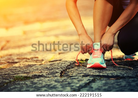 young woman runner tying shoelaces  Foto stock © 
