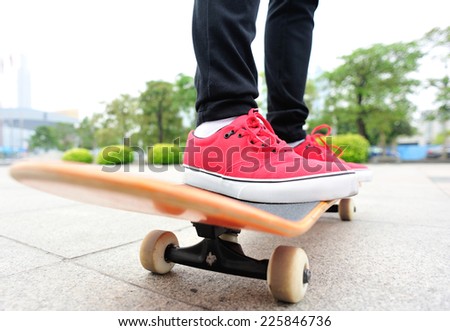 skateboarding woman legs on skateboard