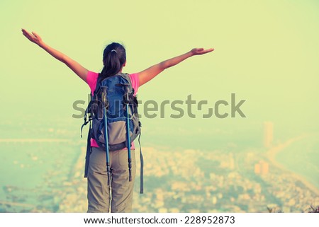 cheering woman hiker seaside mountain peak