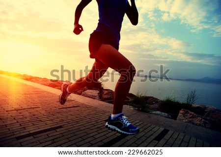 Runner athlete running at seaside. woman fitness sunrise jogging workout wellness concept.