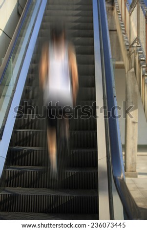 Runner athlete running on escalator stairs . woman fitness jogging workout wellness concept.