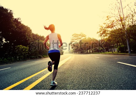 Runner athlete running at road.