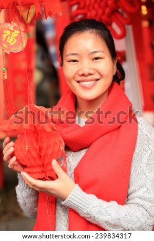 young asian woman with red chinese knot wishing you a happy chinese new year