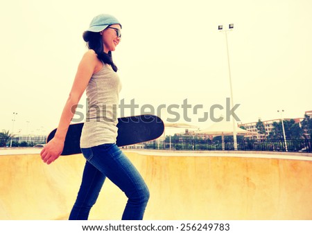 skateboarding woman walking at skatepark