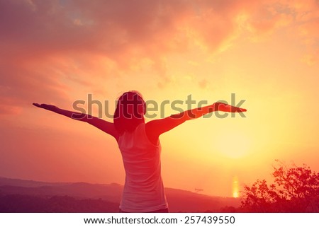 cheering woman open arms mountain peak