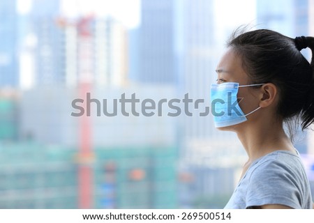 asian woman wear face mask in pollution city