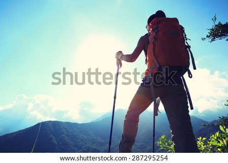 woman backpacker on mountain peak enjoy the view,vintage effect