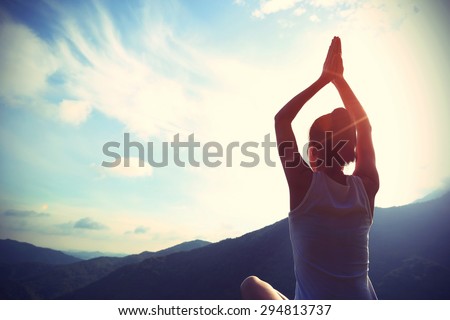 young yoga woman sit meditation on sunrise mountain peak