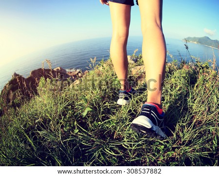 young fitness woman trail runner enjoy the view on seaside mountain trail