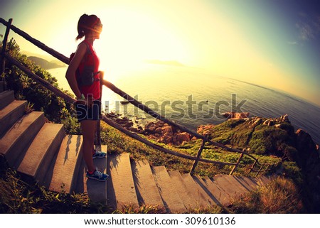 young fitness woman trail runner enjoy the view on seaside mountain trail