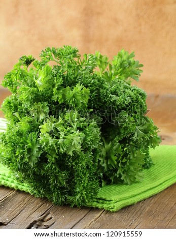 Fresh green, organic parsley on wooden table