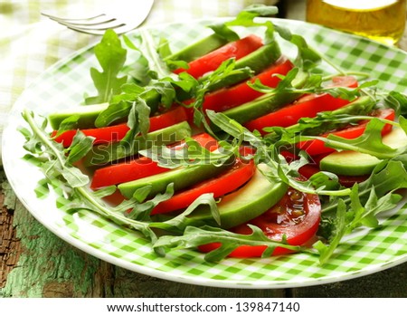 avocado salad with arugula, tomato and olive oil