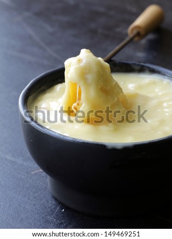 cheese fondue - piece of bread (croutons) in a liquid cheese
