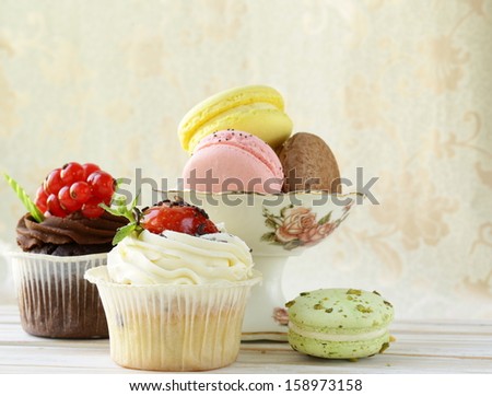 holiday desserts, cupcakes and macaroons on a vintage background