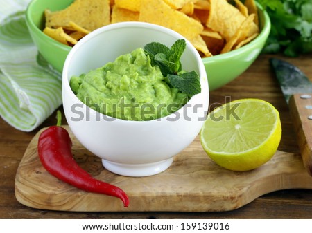 cup with guacamole and corn chips -   Mexican appetizer