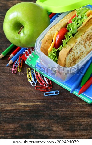 sandwich with cheese and tomato and green apple for a healthy school lunch