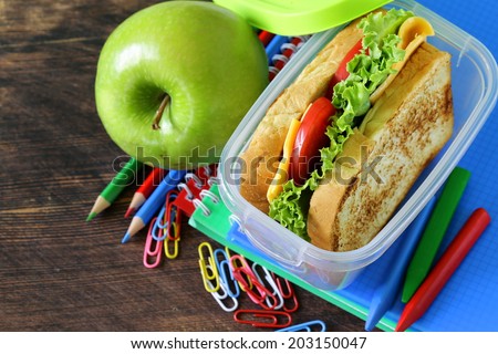 sandwich with cheese and tomato and green apple for a healthy school lunch