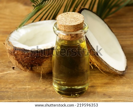 coconut oil in a glass bottle and fresh nuts