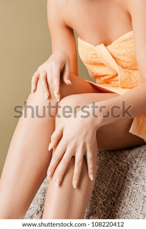 closeup picture of female hands and legs in spa salon