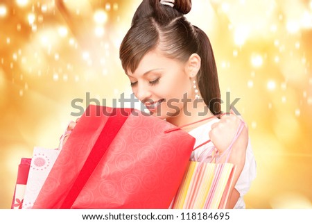 lovely woman with shopping bags over colorful background