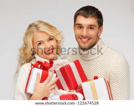 picture of family couple in a sweaters with gift boxes