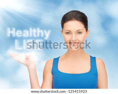 picture of woman holding healthy life words on the palm