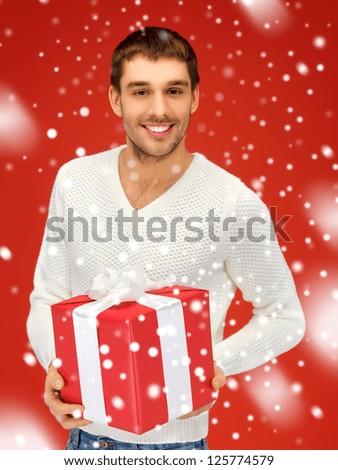 bright picture of handsome man with a gift .