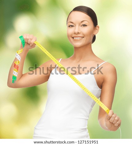picture of sporty woman measuring her hips