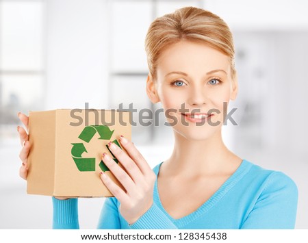 picture of happy woman with recyclable box