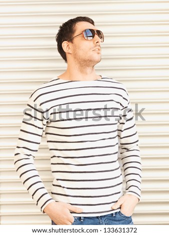 portrait of handsome man in casual clothes  wearing sunglasses