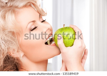 picture of young beautiful woman with green apple