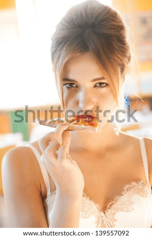picture of sexy woman biting piece of pizza
