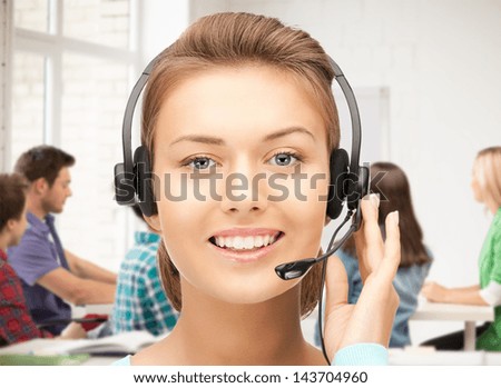 friendly female helpline operator with headphones in office