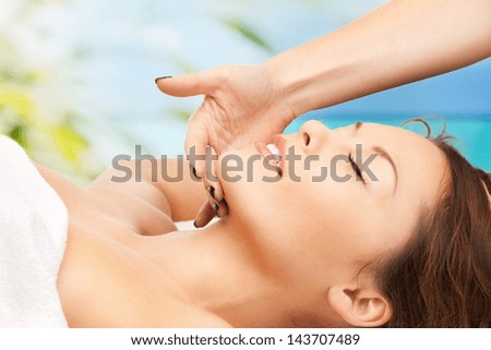 close up of woman on resort getting face spa treatment